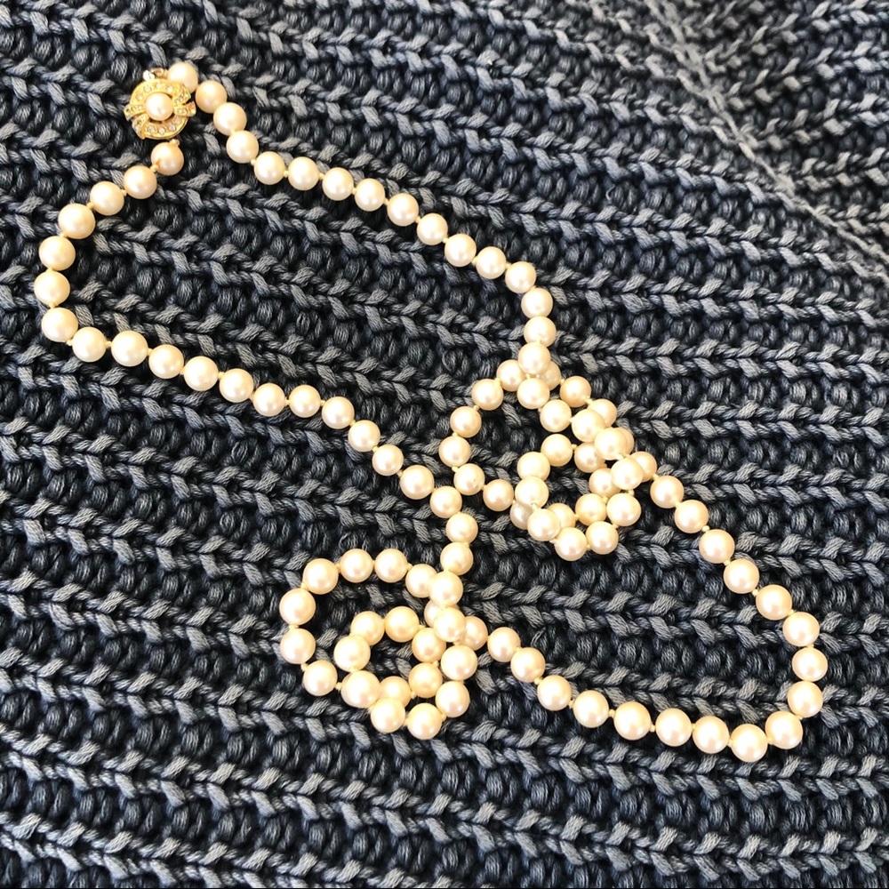 Long strand of small faux pearls  gold tone clasp